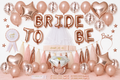 Vrijgezellenfeestversiering in roségoud en roze met Bride To Be letterballonnen, ballonnen, tasselslinger, sluier en bruidsaccessoires.